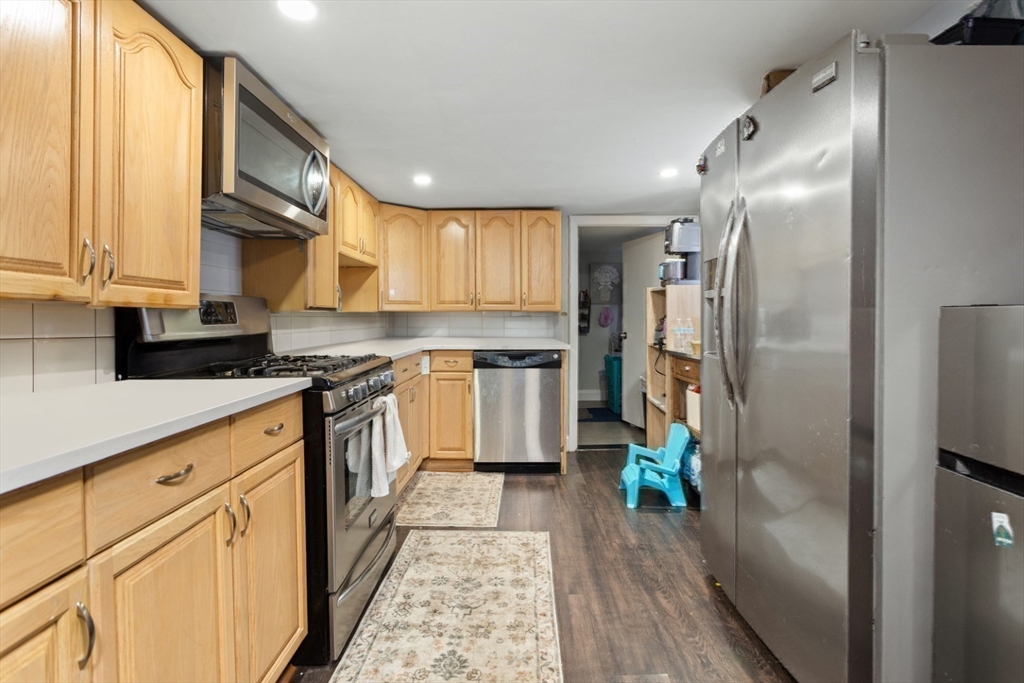 14 Bay Road Revere, MA 02151 - Photo 22 of 38 a kitchen with stainless steel appliances a refrigerator sink and white cabinets