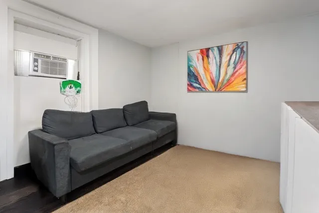 a bedroom with a bed next to a window