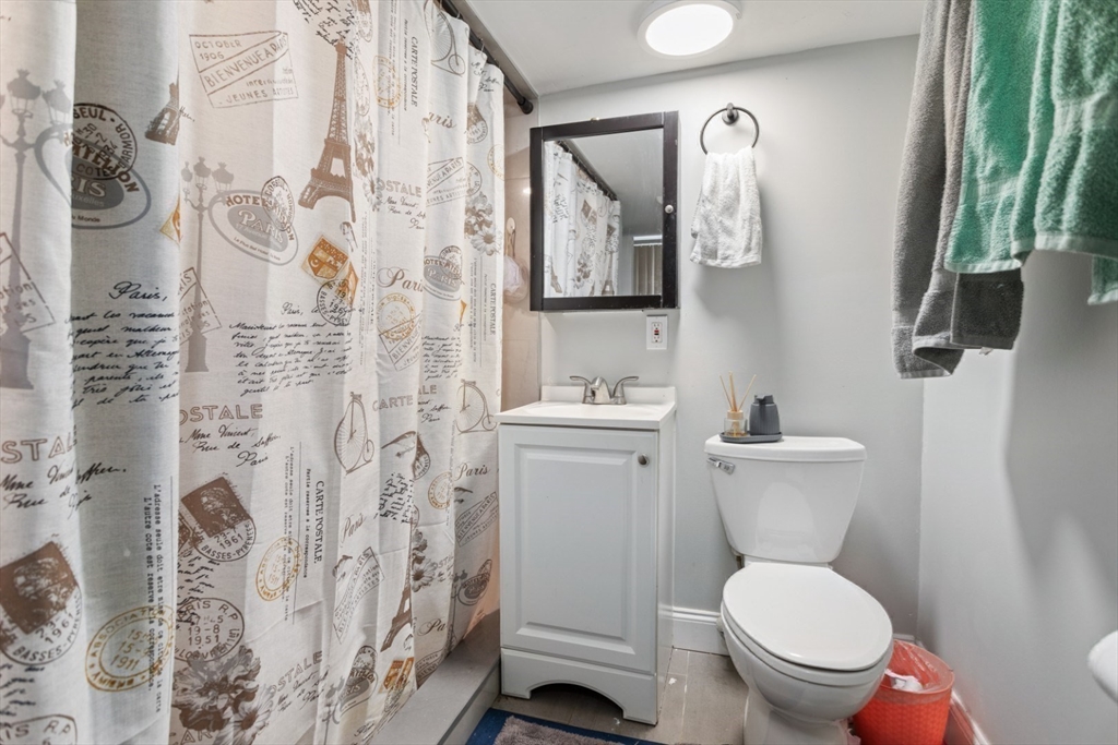 14 Bay Road Revere, MA 02151 - Photo 27 of 38 a white toilet sitting next to a bathroom sink