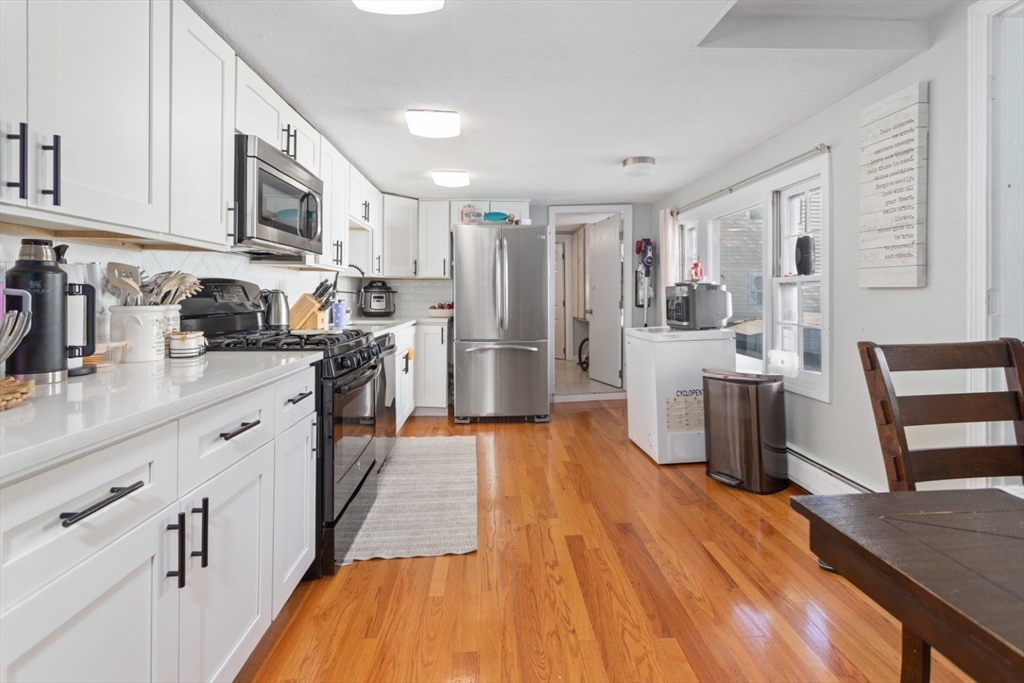 14 Bay Road Revere, MA 02151 - Photo 4 of 38 a kitchen with stainless steel appliances a sink cabinets and wooden floor