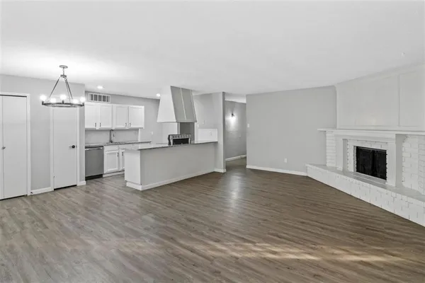 a view of a kitchen with a sink and a stove top oven