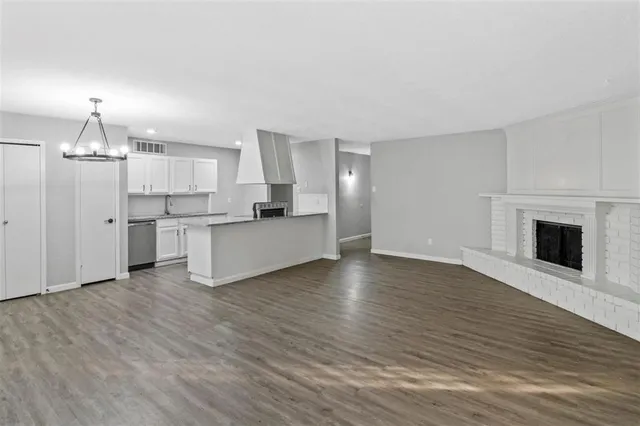 a view of a kitchen with a sink and a stove top oven