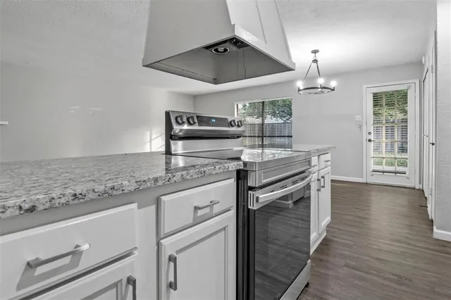 a kitchen with stainless steel appliances granite countertop a sink and a stove