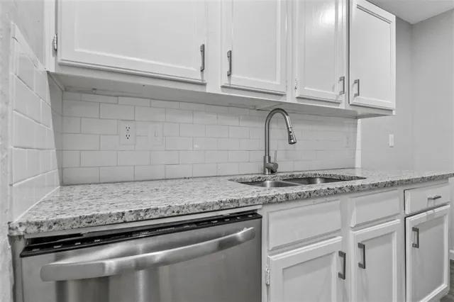 a view with granite countertop white cabinets and a granite counter tops