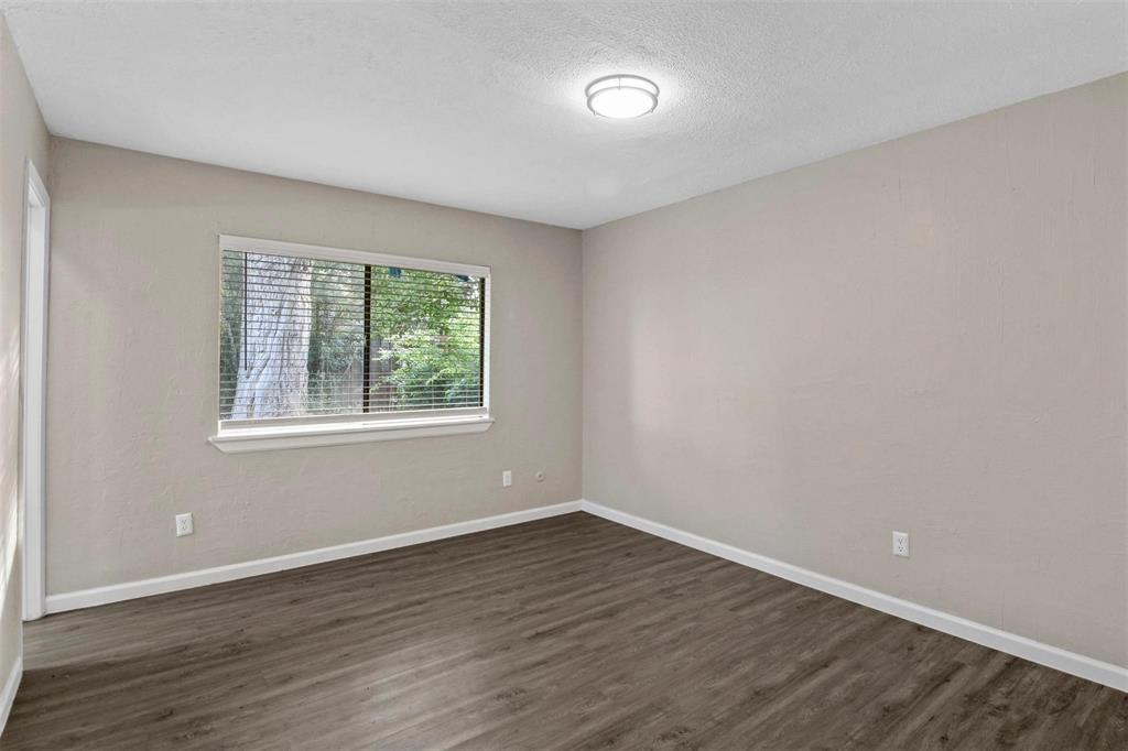 519 Windsor Drive Allen, TX 75002 - Photo 7 of 11 a view of an empty room with wooden floor and a window