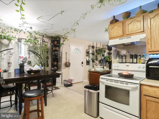 a kitchen with stainless steel appliances granite countertop a stove a refrigerator and a dining table