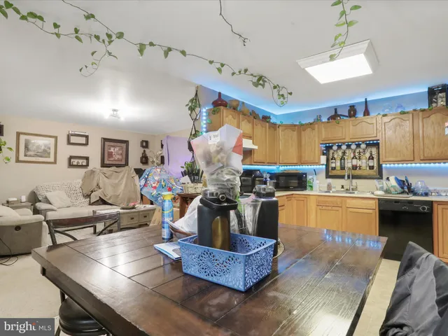 a living room with furniture and a kitchen