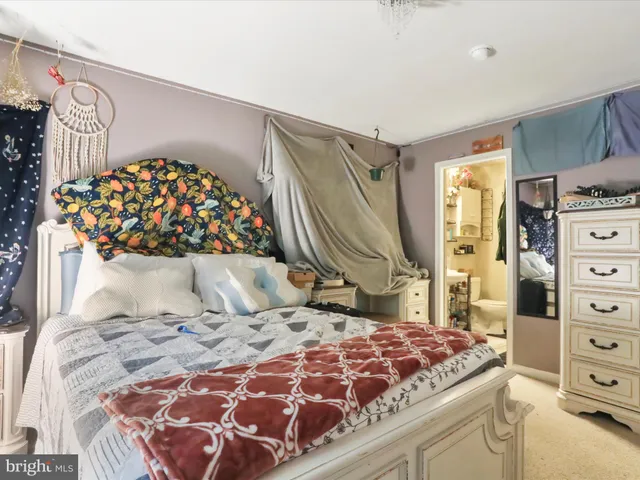 a bedroom with a large bed and a dresser