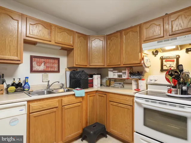 a kitchen with stainless steel appliances a sink stove and cabinets