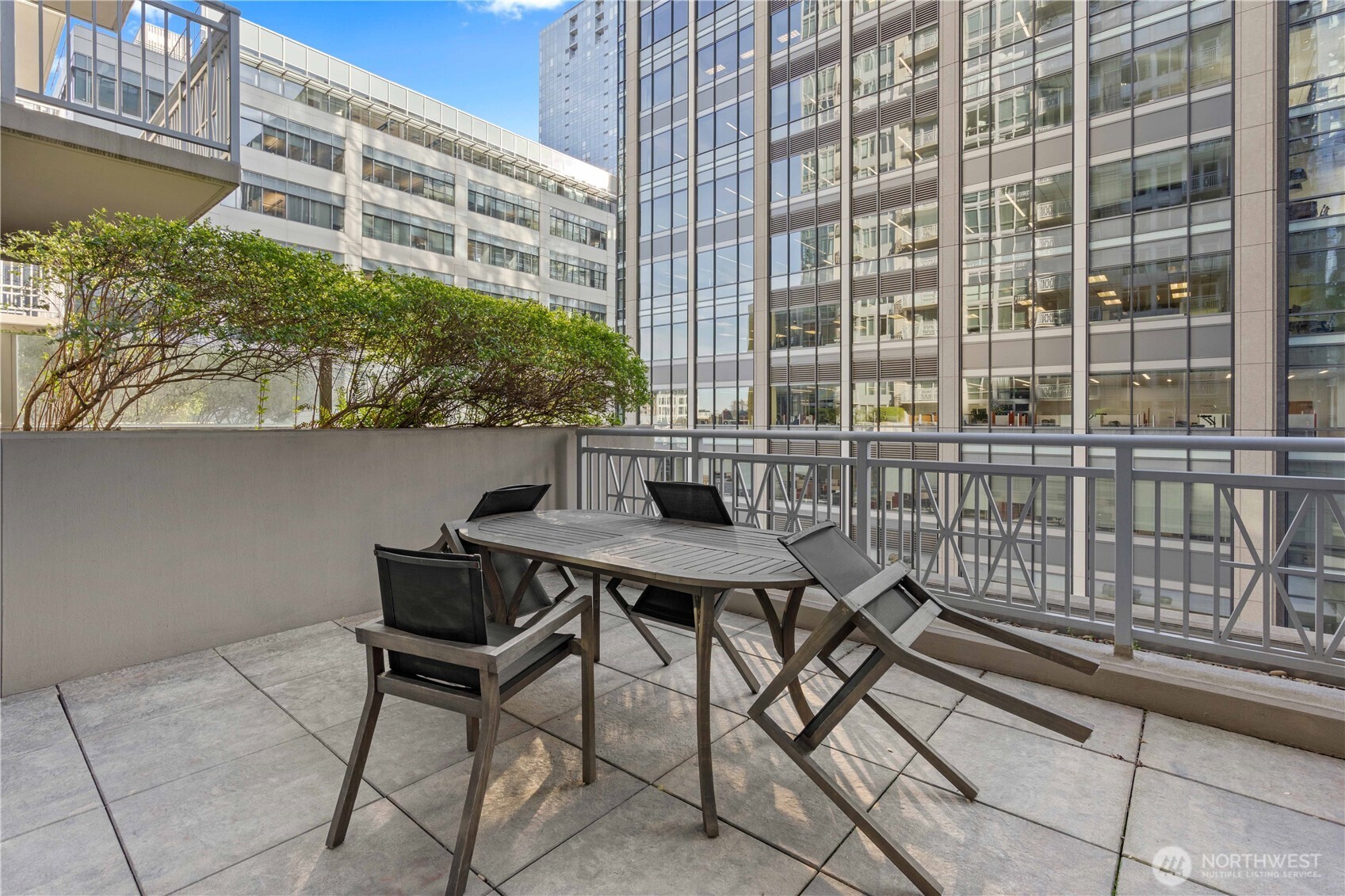 819 Virginia Street, Unit 1408 Seattle, WA 98101 - Photo 25 of 39 a view of a balcony with a table and chairs