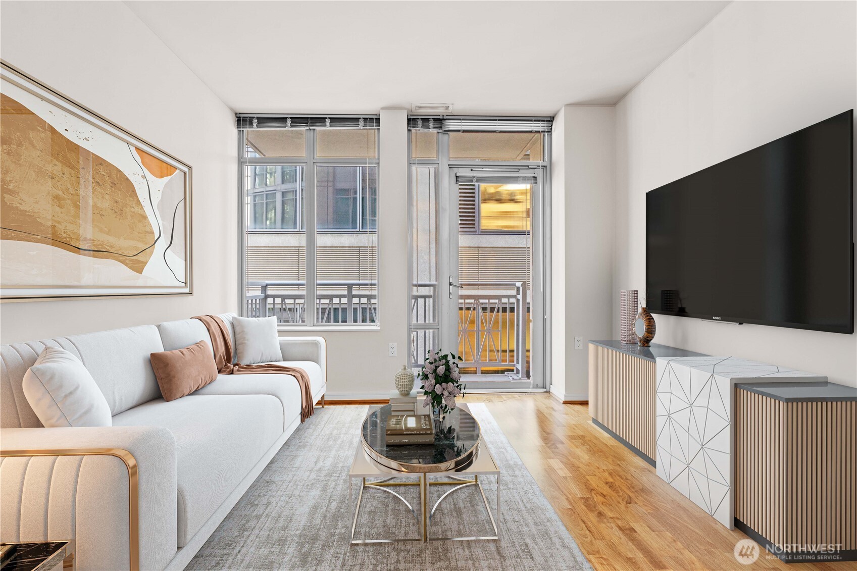 819 Virginia Street, Unit 1408 Seattle, WA 98101 - Photo 9 of 39 a living room with furniture a flat screen tv and a floor to ceiling window