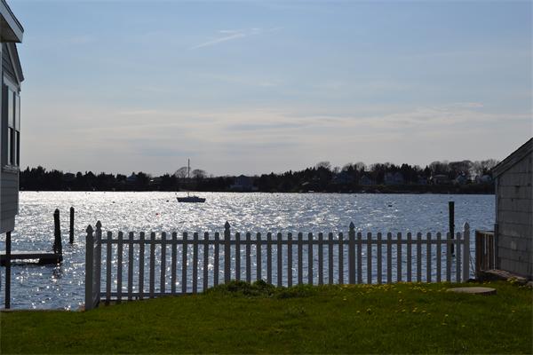 21 Riverside Drive Tiverton, RI 02878 - Photo 8 of 8 a view of a wooden deck with a lake