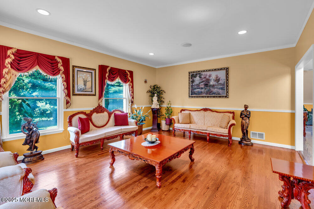 1721 Azure Drive Neptune, NJ 07753 - Photo 26 of 95 a living room with furniture a rug and a painting on the wall
