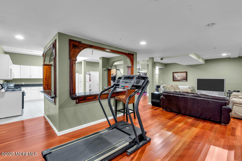1721 Azure Drive Neptune, NJ 07753 - Photo 86 of 95 a living room with furniture a wooden floor and a flat screen tv