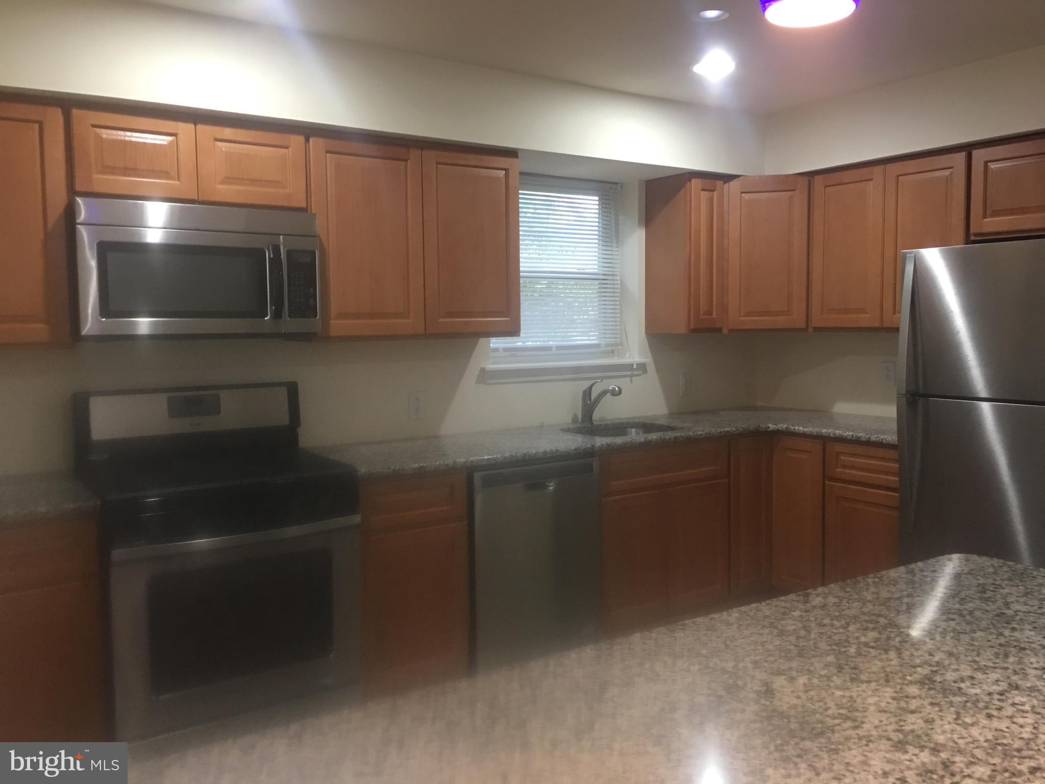 25 Zane Street, Unit A Glassboro, NJ 08028 - Photo 5 of 16 a kitchen with a refrigerator and a sink