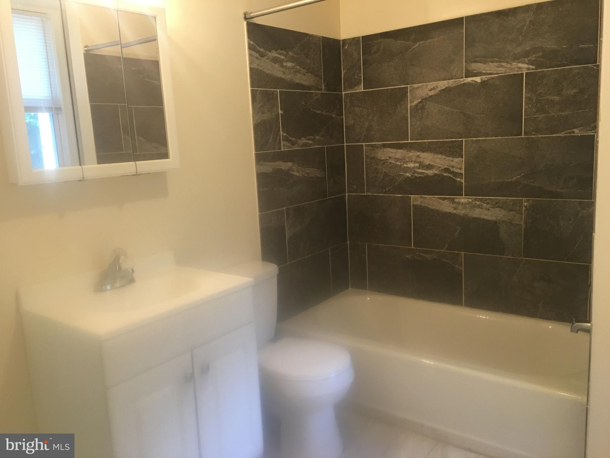 25 Zane Street, Unit A Glassboro, NJ 08028 - Photo 8 of 16 a bath tub sitting next to a white sink