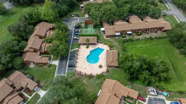 an aerial view of a house with a yard and outdoor seating