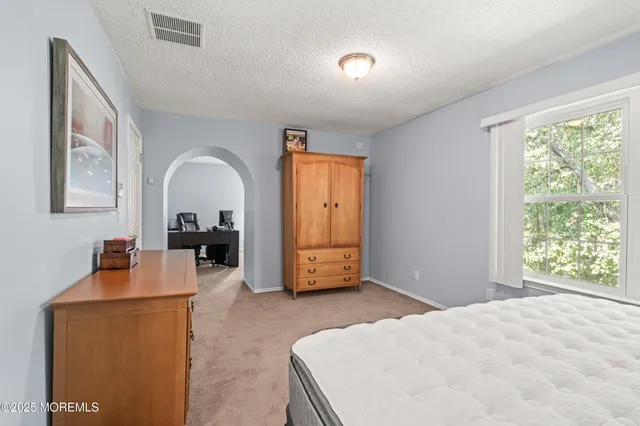 a view of livingroom with workspace and a window
