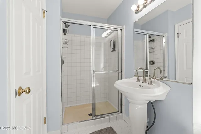 a bathroom with a sink a mirror and a shower