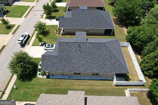 an aerial view of a house with a yard