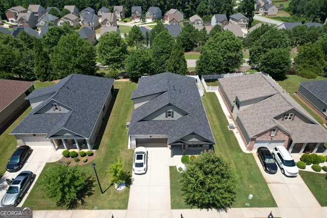 an aerial view of multiple houses with a yard