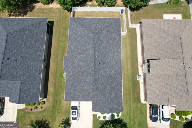 aerial view of a house with a yard and plants