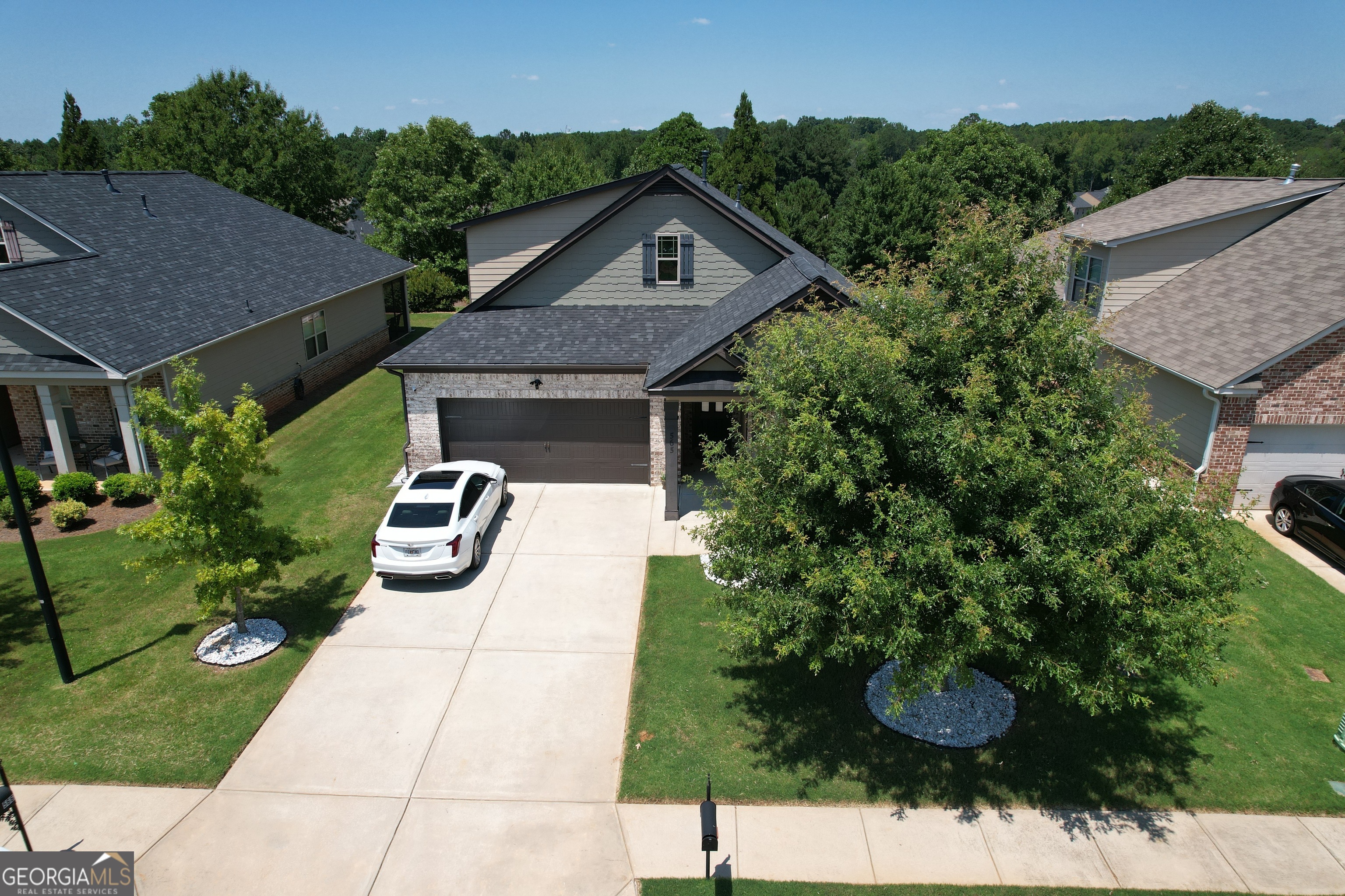 565 Carleton Place Locust Grove, GA 30248 - Photo 2 of 40 a front view of a house with a yard and garage