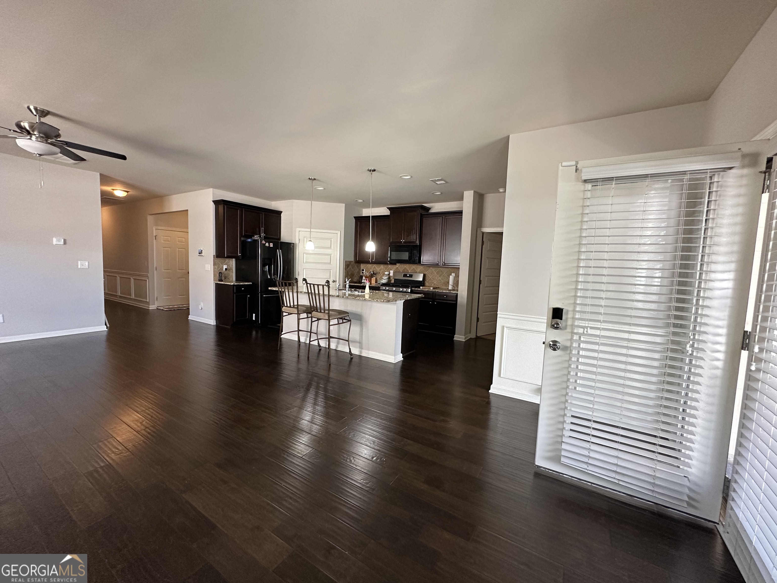 565 Carleton Place Locust Grove, GA 30248 - Photo 24 of 40 a view of a kitchen with a sink a refrigerator cabinets and wooden floor