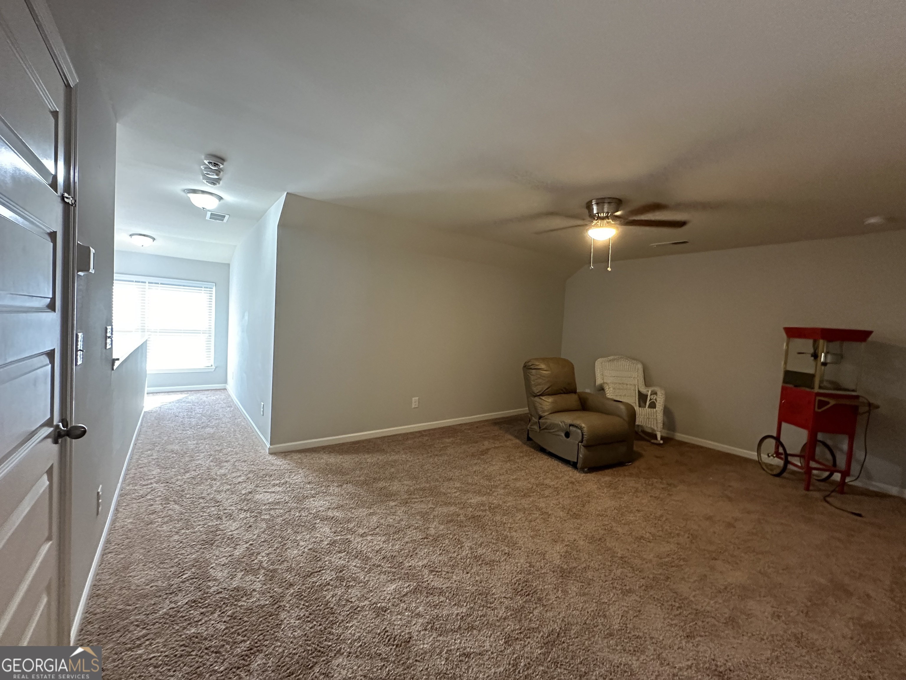 565 Carleton Place Locust Grove, GA 30248 - Photo 26 of 40 a view of a livingroom with furniture and a chandelier