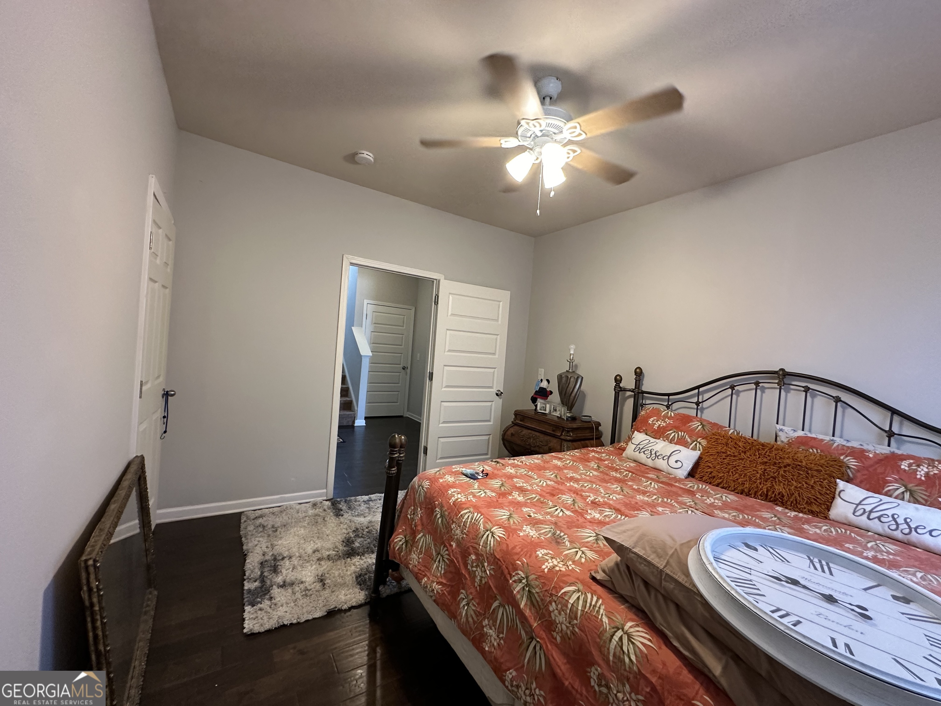 565 Carleton Place Locust Grove, GA 30248 - Photo 28 of 40 a bedroom with a bed and a chandelier