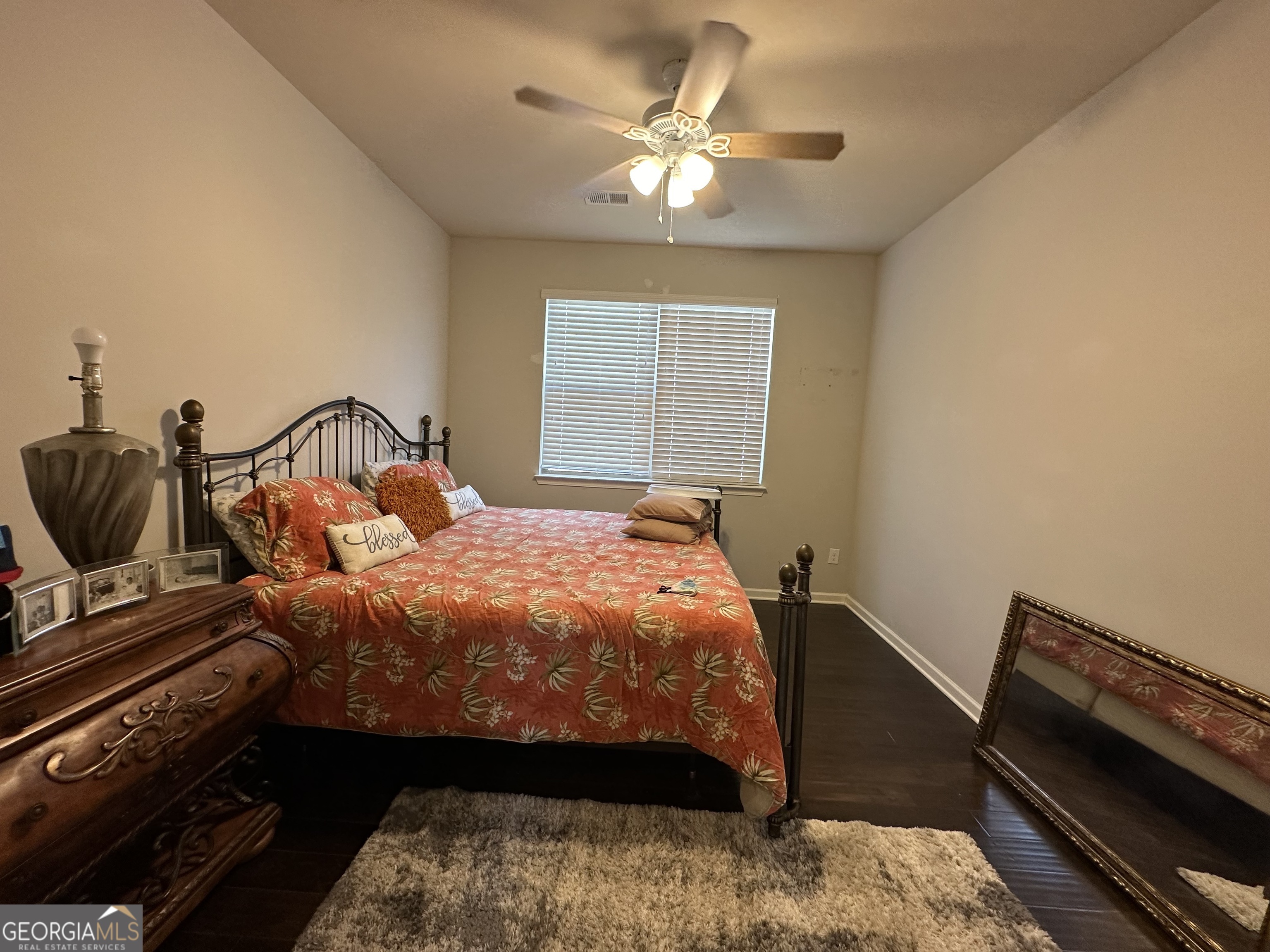 565 Carleton Place Locust Grove, GA 30248 - Photo 29 of 40 a bedroom with a bed and a chandelier