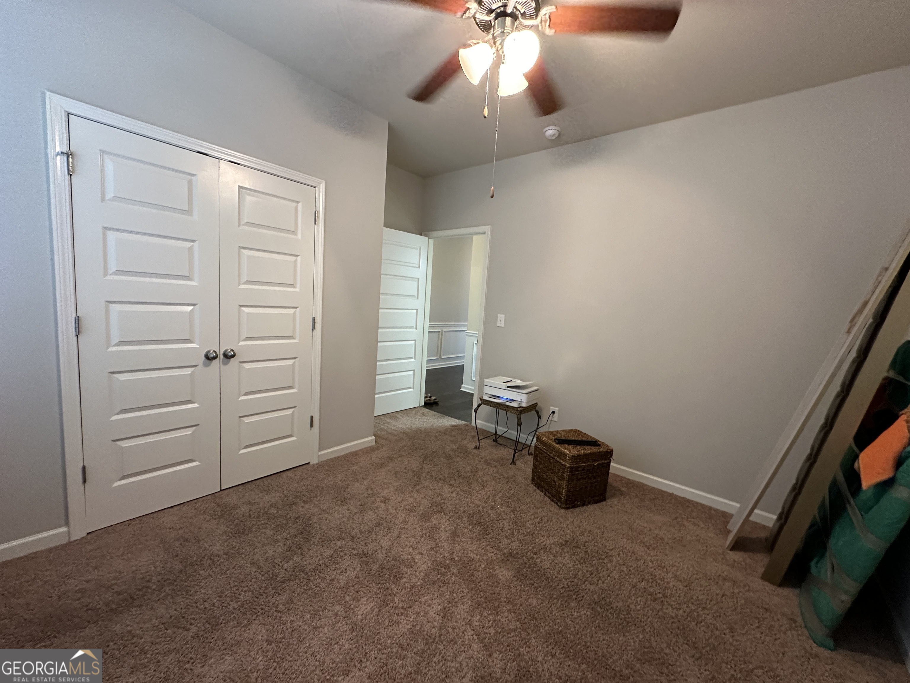 565 Carleton Place Locust Grove, GA 30248 - Photo 31 of 40 an empty room with closet and a chandelier fan