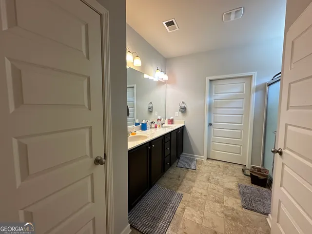 a bedroom with a bed and flat screen tv