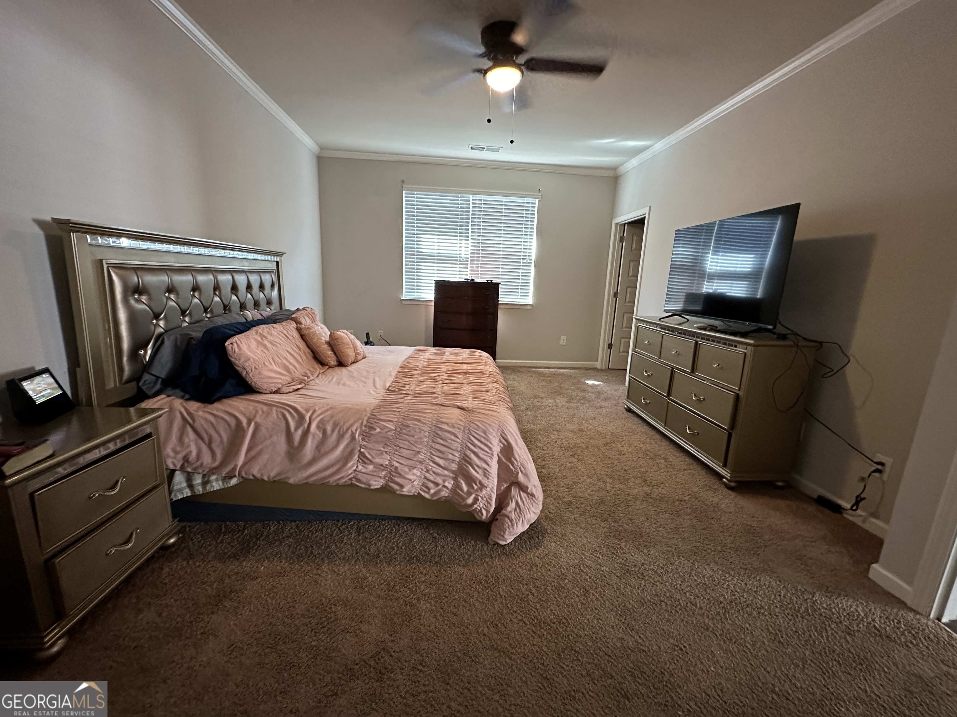 565 Carleton Place Locust Grove, GA 30248 - Photo 36 of 40 a bedroom with a bed and flat screen tv