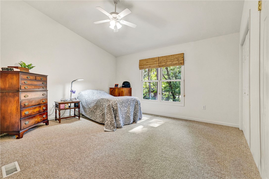 114 Summersweet Lane Seneca, SC 29672 - Photo 11 of 25 A spacious bedroom offers plush neutral carpeting and a wide window overlooking peaceful woods.