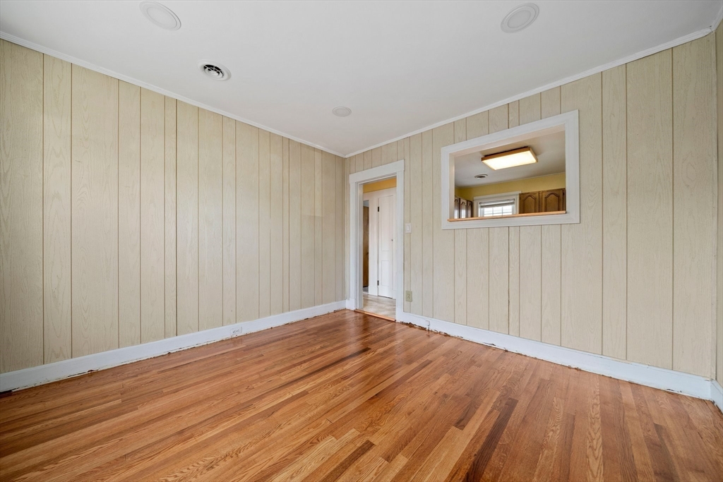 12 Cotuit Street Boston, MA 02132 - Photo 6 of 19 a view of an empty room with wooden floor