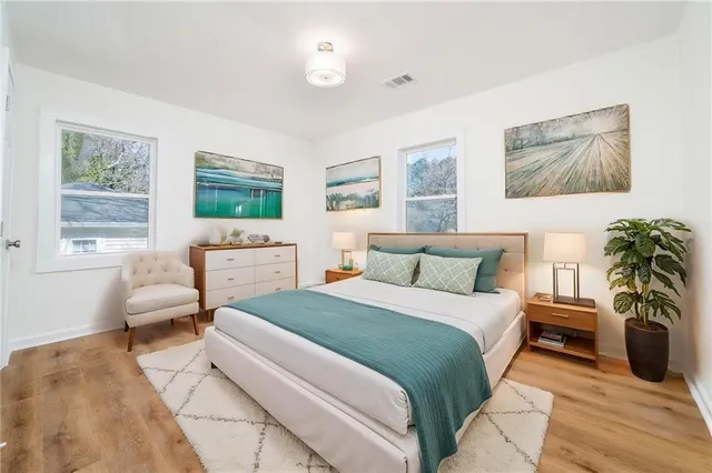 a bedroom with a large bed couch and a window