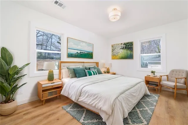 a bedroom with a bed and wooden floor