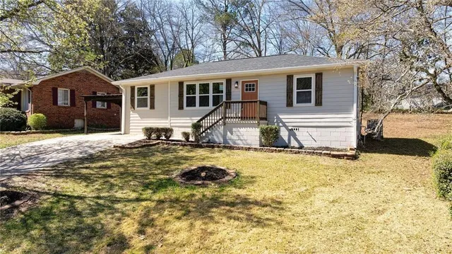 a view of a house with snow on the side of the road