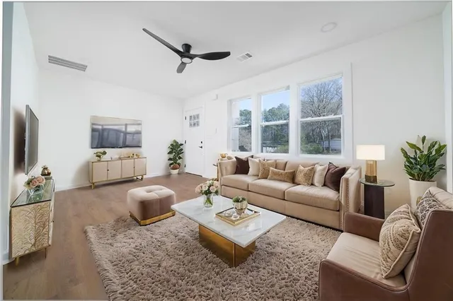 a living room with furniture and a flat screen tv