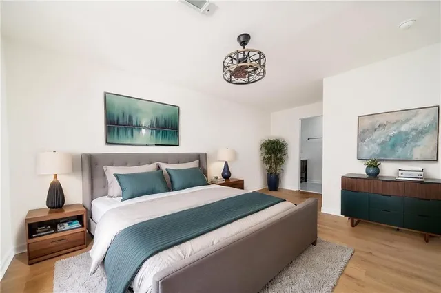 a bedroom with a large bed and a chandelier