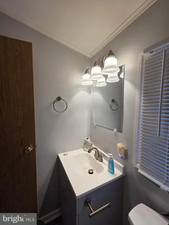 a bathroom with a sink mirror and toilet