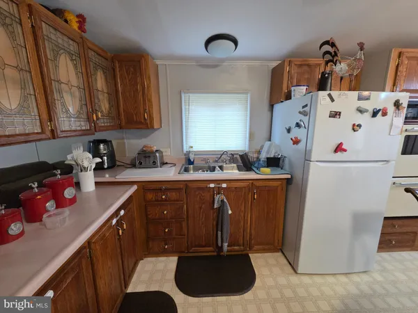 a kitchen with sink a refrigerator and cabinets