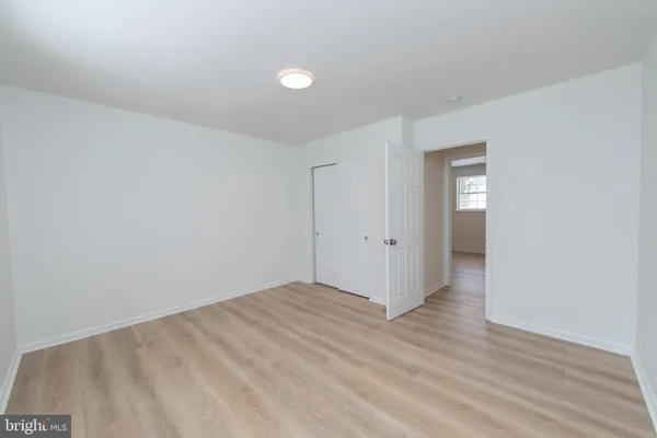 a view of an empty room and wooden floor