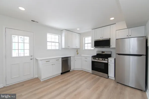 a kitchen with a refrigerator stove and microwave