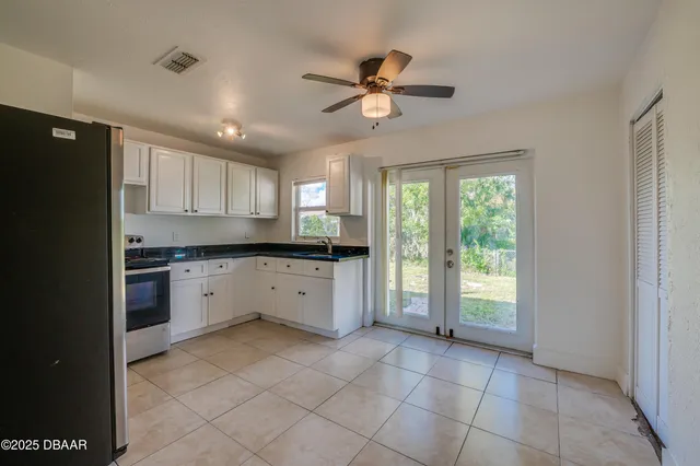 a kitchen with a refrigerator a sink and cabinets