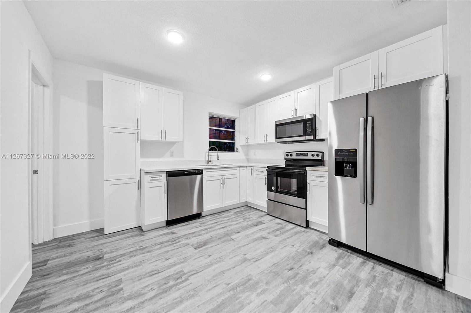 18951 Southwest 311th Street Homestead, FL 33030 - Photo 1 of 20 a kitchen with stainless steel appliances a refrigerator sink and microwave