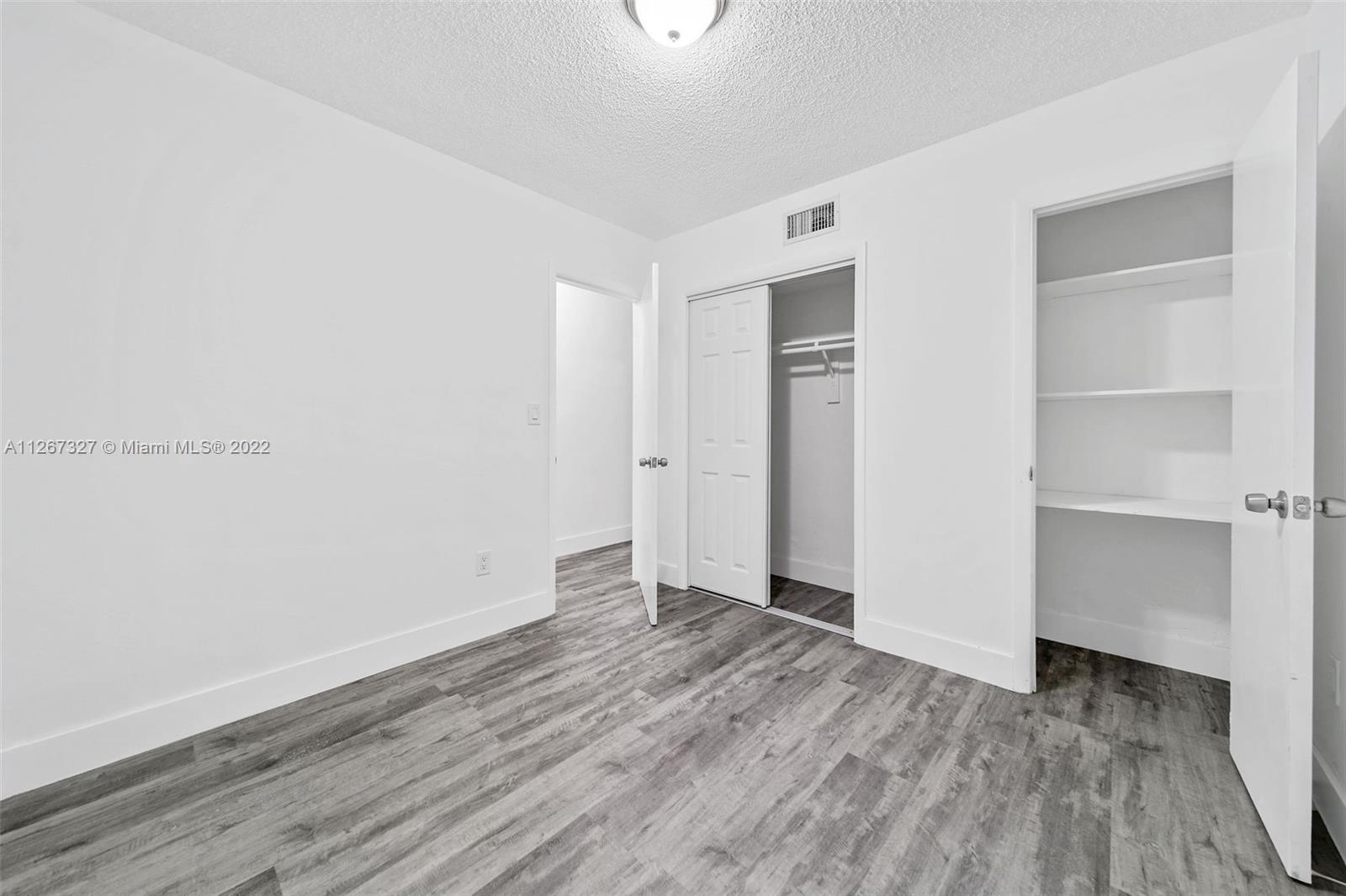 18951 Southwest 311th Street Homestead, FL 33030 - Photo 11 of 20 a view of an empty room with closet and wooden floor