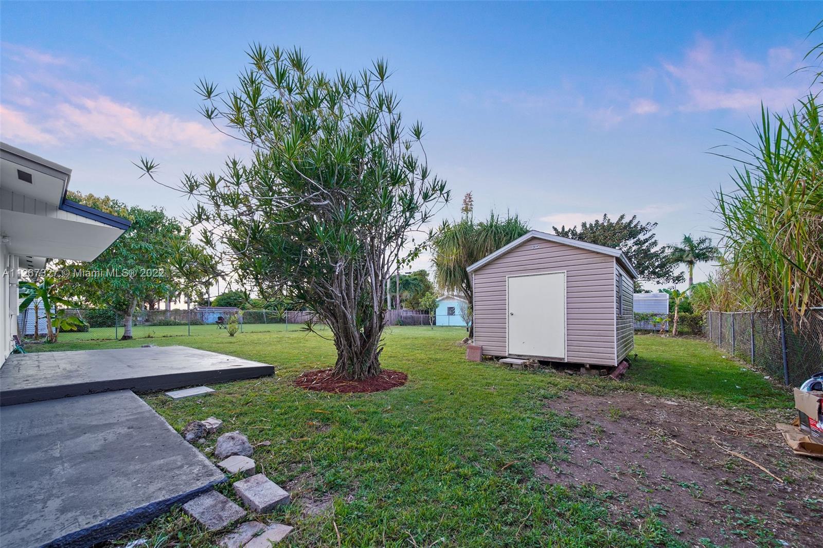 18951 Southwest 311th Street Homestead, FL 33030 - Photo 19 of 20 a view of a house with a tree and a yard