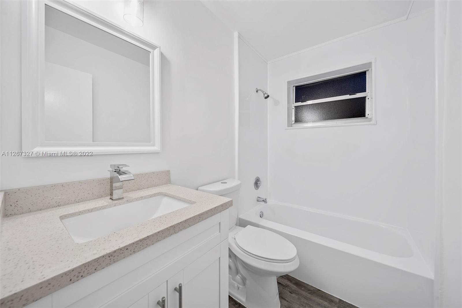 18951 Southwest 311th Street Homestead, FL 33030 - Photo 8 of 20 a bathroom with a sink a toilet and shower